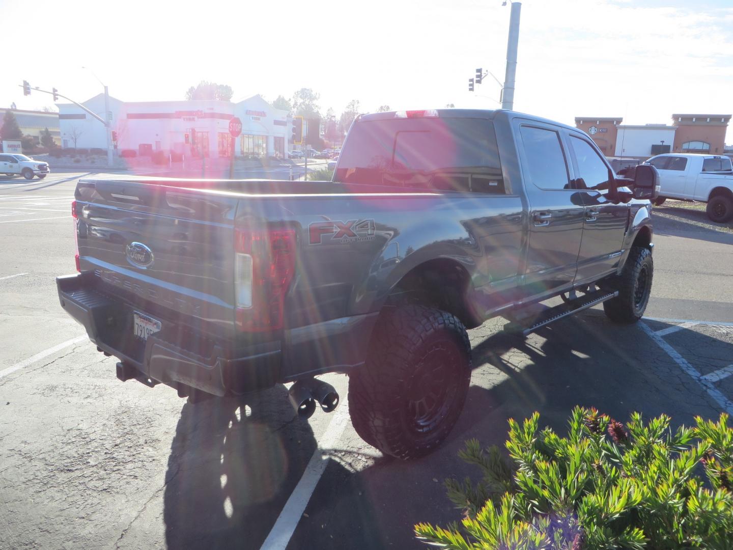 2019 CHARCOAL /BLACK Ford F-350 SD Lariat Crew Cab 4WD (1FT8W3BT7KE) with an 6.7L V8 OHV 16V DIESEL engine, 6A transmission, located at 2630 Grass Valley Highway, Auburn, CA, 95603, (530) 508-5100, 38.937893, -121.095482 - Leveled Superduty sitting on 20" XD series wheels, 35" Nitto Ridge Grappler tires, window tint, and has Firestone Air bags. - Photo#3